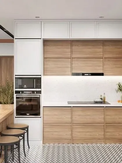 A warm and inviting kitchen that combines white upper cabinets with natural wood-finish lower cabinets. This space is integrated with a dining area, making it a social hub for the home.
