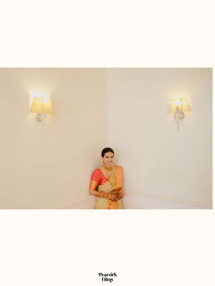 A minimalist and modern portrait of the bride, framed by two simple wall lamps, letting her natural grace be the focus.