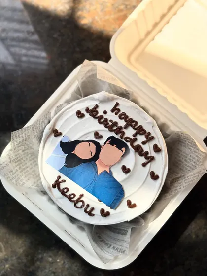 A personalized bento cake featuring a custom faceless illustration of a couple. This is a wonderful way to add a personal touch to a birthday or anniversary cake.