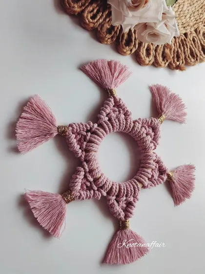 Another view of the star-shaped macrame placemat. The tassels add a lovely, decorative touch.