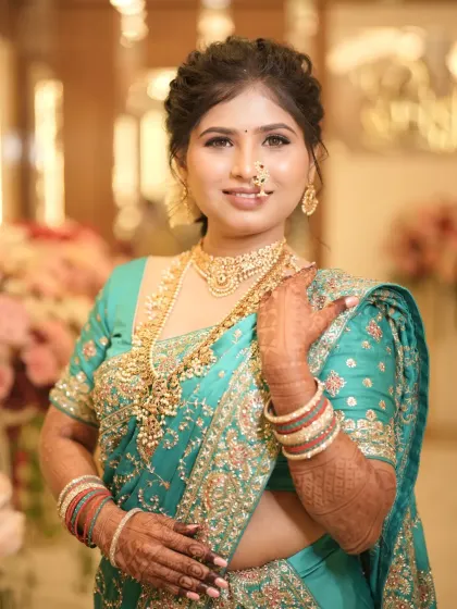 This bride is shining from within. A beautiful reception look in a turquoise saree with intricate embroidery.
