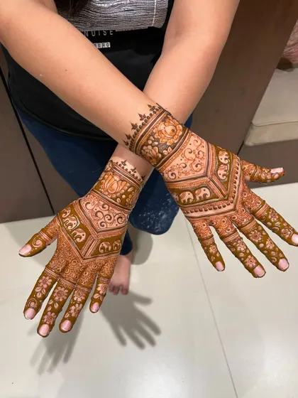 A beautiful back-hand design with elephants and lotus motifs, creating a V-shape pattern.