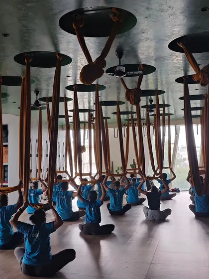 A beautiful, symmetrical shot of my aerial yoga class in a seated meditation pose. This image captures the sense of community, discipline, and shared focus in our studio.