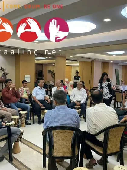 An intimate corporate session where participants are seated closely in a circle. This setup fosters a strong sense of connection and allows for more nuanced rhythmic interplay.