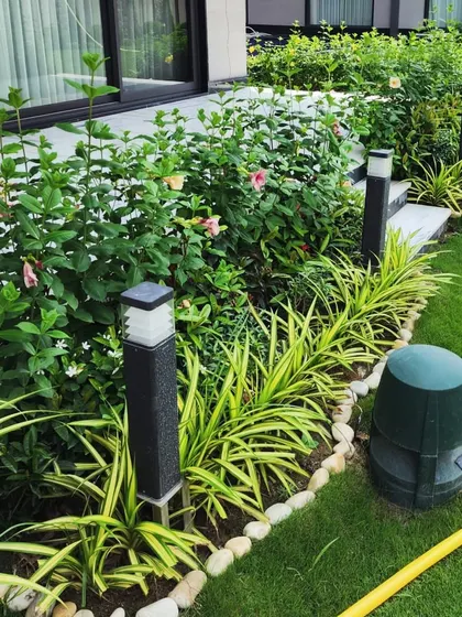 A close-up of the flowering hedge and pathway lighting at our G-Town Wines project. We pay close attention to details like stone borders and integrated lighting to complete the premium look.