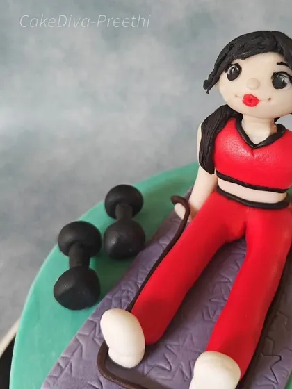 Another angle of the fitness-themed fondant topper. I can create personalized figures that represent any hobby or profession.