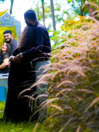 A romantic embrace captured through the reflection in a mirror, surrounded by nature. This is a creative technique I use for unique pre-wedding shots.