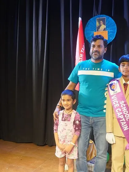 A student leader poses with his family, holding his new sash of responsibility. We celebrate these moments of achievement with the families who support our young leaders.