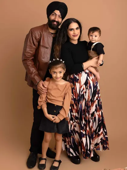 A full-length family portrait in the studio. I help guide you into poses that feel natural and look great, ensuring everyone is comfortable and smiling.
