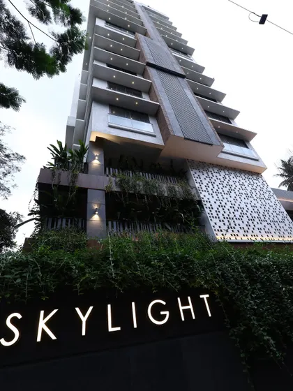 The Skylight building at dusk, where architectural form meets carefully orchestrated light. The illuminated signage and articulated facade details create a strong identity, showcasing how contemporary design can make a powerful statement in the urban environment.