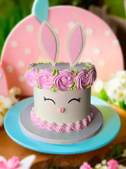 A cute Easter bunny cake with fluffy ears and a floral crown of buttercream roses. This one is a favorite among kids!