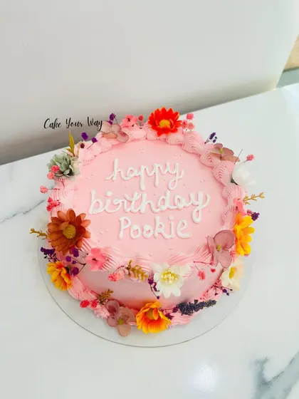 A beautiful floral cake in shades of pink, perfect for a special birthday.