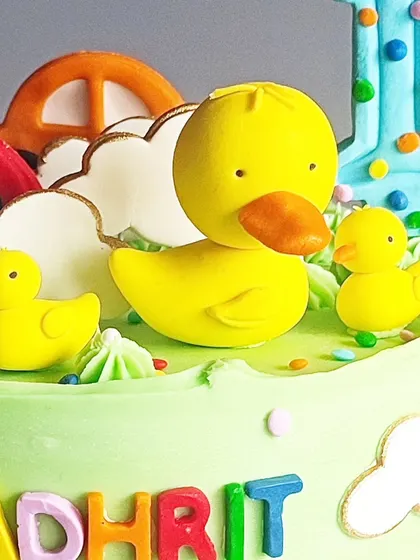 A close-up of the adorable, handcrafted duck family on top of the car-themed cake.