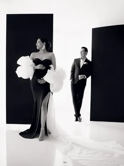 A dramatic and stylish black and white portrait. The composition, with the mamma in the foreground and her partner in the back, creates a cool, editorial feel.