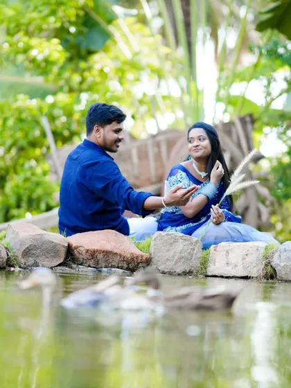 A romantic scene by a pond, with ducks swimming in the foreground. This adds a lovely, natural element to the pre-wedding story.