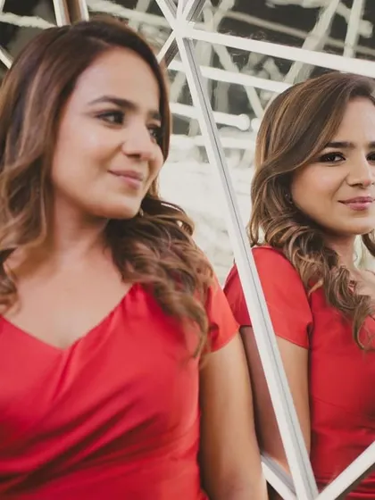 Anisha looking like a doll in this contemporary red dress, perfect for a celebratory evening. The makeup is soft and glowy, with a hint of drama in the eyes.