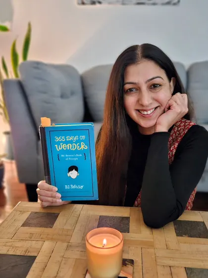 I believe in the power of wondering, pondering, and reflecting in writing. Here I am with the book '365 Days of Wonder,' which inspired me to start a weekly writing reflection with my community to spark 'aha' moments and self-discovery.