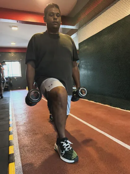 A client performs walking lunges down our track, a fundamental exercise for building leg strength and endurance.
