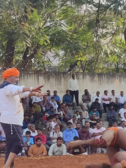 Instructing a wrestler from the sidelines during a tense moment in the match. Every move counts in the art of Kusti.
