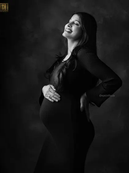 Pure, unfiltered emotion captured in a timeless black and white portrait. This image focuses on the sheer joy and radiance of the mom-to-be, proving that sometimes the simplest shots are the most powerful.