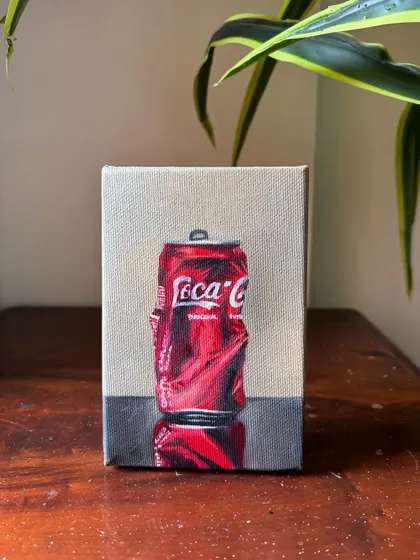 A realistic oil painting of a crushed Coca-Cola can, focusing on the way light reflects off the crumpled metal. It's a fun study in realism and pop art.