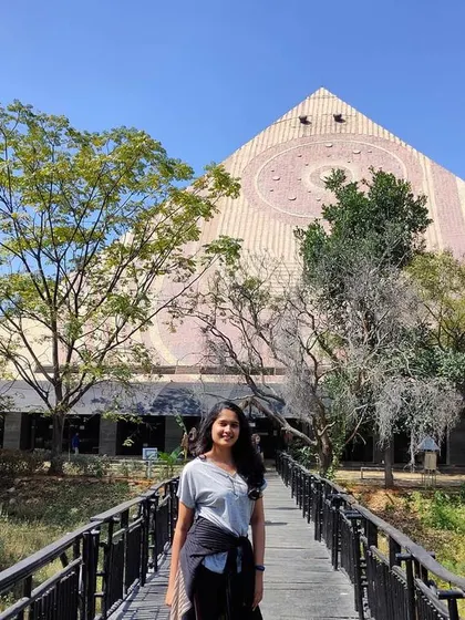Standing on a bridge in front of the Maitreya-Buddha Pyramid in Bangalore. I am always exploring places of peace and spiritual energy.