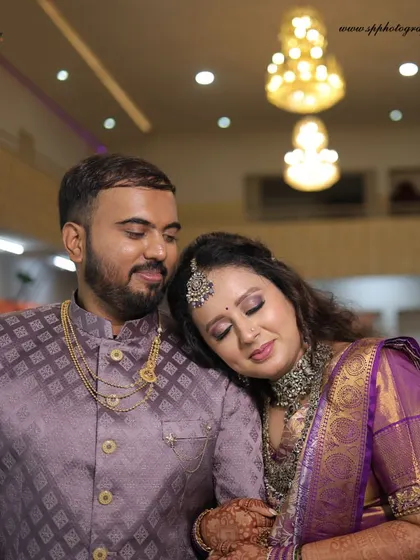 A tender moment between the couple during their reception. The bride resting her head on the groom's shoulder creates a feeling of comfort and love.