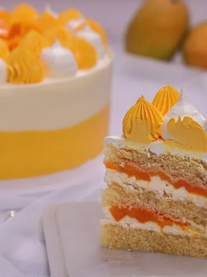 We capture the taste of summer with our fresh mango cake. This light and airy cake is layered with mango filling and topped with fresh, juicy mango chunks and piped cream, making it a perfect treat for Father's Day or any warm-weather celebration.