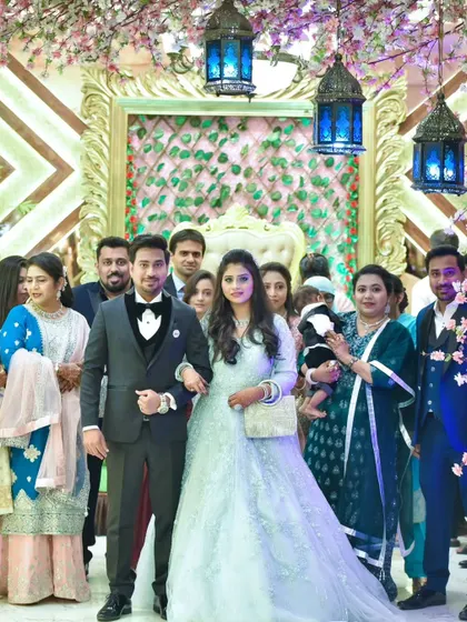 A photograph of the couple with their family and friends at the reception, capturing a moment of shared celebration.