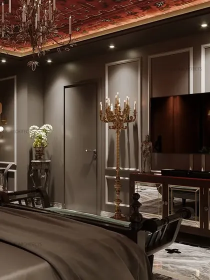 The opposite view of the classic-themed bedroom, showing the TV console and ornate floor-standing candelabras that enhance the room's grand, royal aesthetic.