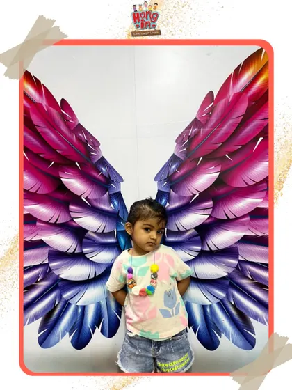 Another little angel in front of our colorful wings. It’s a perfect spot for a memorable photo after a fun class.