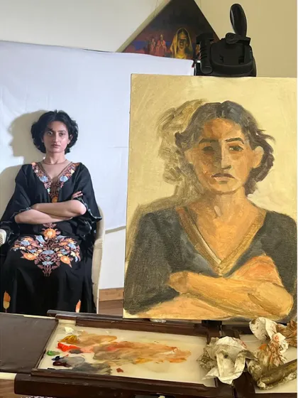 Another shot from the live session with Anamaya, showing my easel and palette setup. You can see the colors I mixed to capture her skin tones and the tones of her dress.