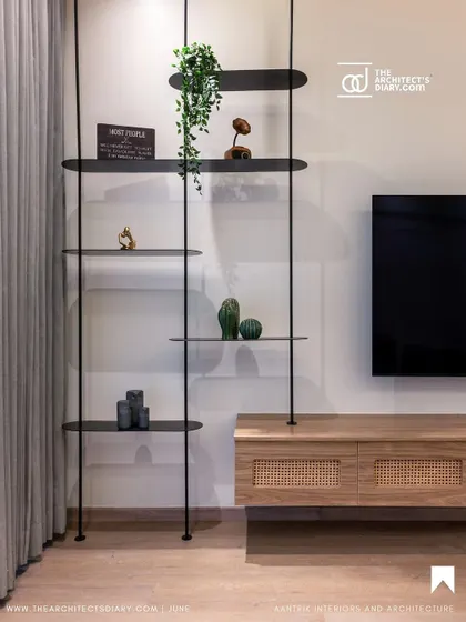 This detail shot from The Architect's Diary feature shows a custom-designed floating shelf system and a wicker-front media console, demonstrating my love for clean lines and natural textures.