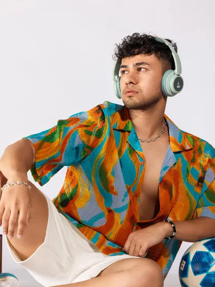 A vibrant, tropical-themed shoot for a men's summer collection. I paired a colorful printed shirt with white shorts and casual accessories like headphones and a speaker to create a fun, youthful, and energetic vibe.