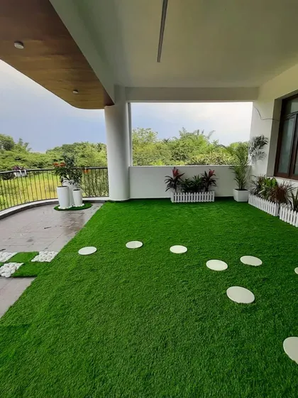 We can handle large spaces too. This expansive terrace was covered in high-quality artificial turf with stepping stones, creating a massive, low-maintenance lawn with a beautiful open view.