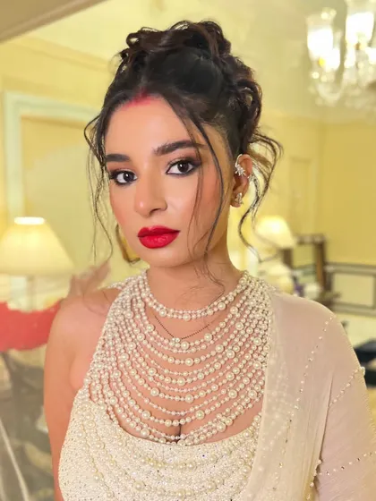 A portrait of the bride, her modern updo adding a fashionable edge to her reception look.
