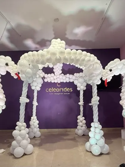 An impressive balloon sculpture of swans and a canopy, made by students in my event management course.