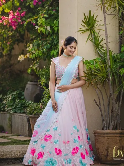 This pastel lehenga is perfect for a daytime event like a Mehendi or pre-wedding shoot. The makeup is kept soft and fresh, with a simple ponytail hairstyle.