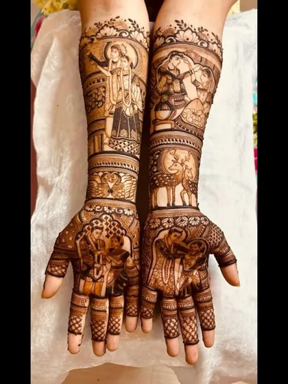 A unique bridal design incorporating the divine love of Radha and Krishna alongside portraits of the couple, blending spiritual and personal stories.
