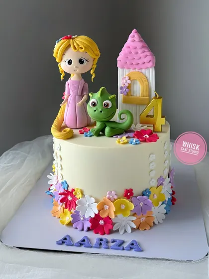 The cutest Rapunzel cake for a princess lover. This design features a handcrafted Rapunzel figurine with her long hair, Pascal, and her iconic tower.