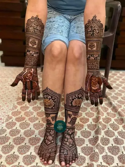 A complete bridal look with matching portrait mehandi on the hands and intricate floral and lotus designs on the feet.