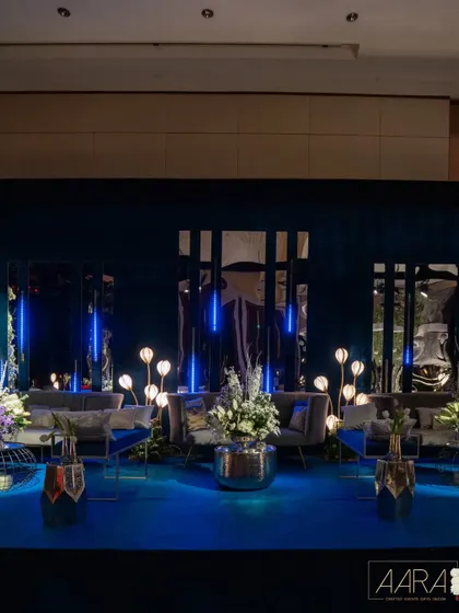 The lounge area for the 'Gala Galaxy Night' was designed to feel like a futuristic celestial space. I used sleek, modern furniture, deep blue carpeting, and unique floral-inspired floor lamps to create a cool, cosmic vibe.