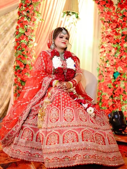 My gorgeous bride Shashi, ready for her wedding ceremony. The bright red flowers in the background make her red lehenga pop even more.