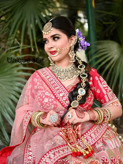 Another beautiful shot of the bride in her red lehenga. The side view highlights the braid accessory and the heavy earrings from the rental set.