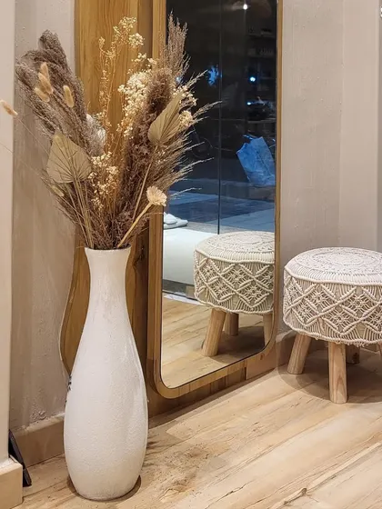 A quiet corner of the studio. The combination of natural textures, like this dried pampas grass arrangement, and modern decor creates a warm and inviting feel.