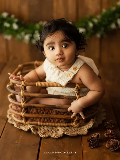 A curious and wide-eyed expression from a baby during their sitter session. These portraits are perfect for capturing their budding personality.