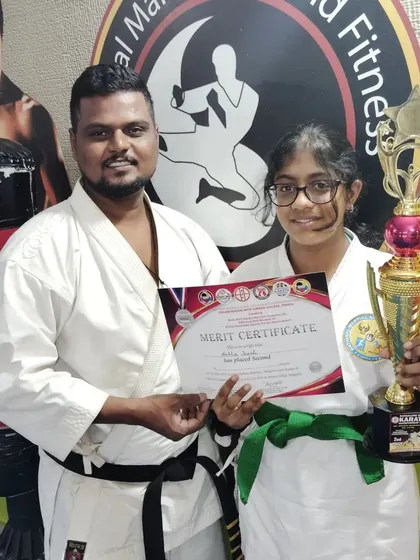 A second-place win for this green belt student, showcasing her achievement with a certificate and trophy.