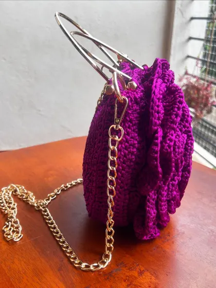 The elegant gold chain and hardware on the purple Rose Bag make it a truly luxurious accessory.