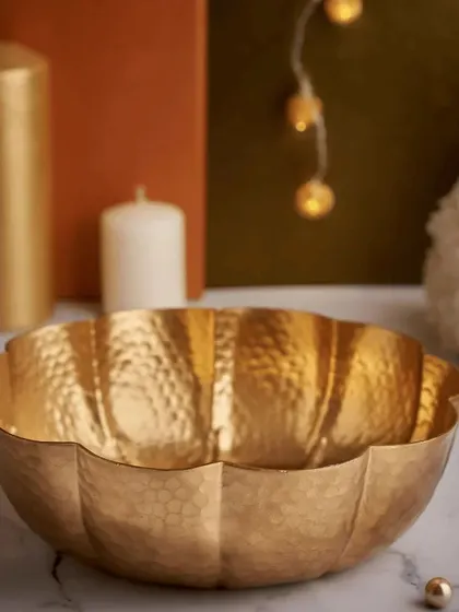 This scalloped, hammered brass bowl is another beautiful favor option. Its unique shape and warm metallic finish make it a standout decorative piece for any home.