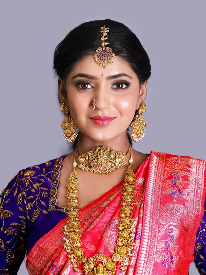 A close-up portrait highlighting the maang tikka and earrings.